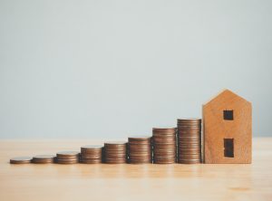 Property investment real estate and house mortgage financial concept, Money coin stack with wooden house